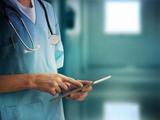 A nurse checking information on the tablet