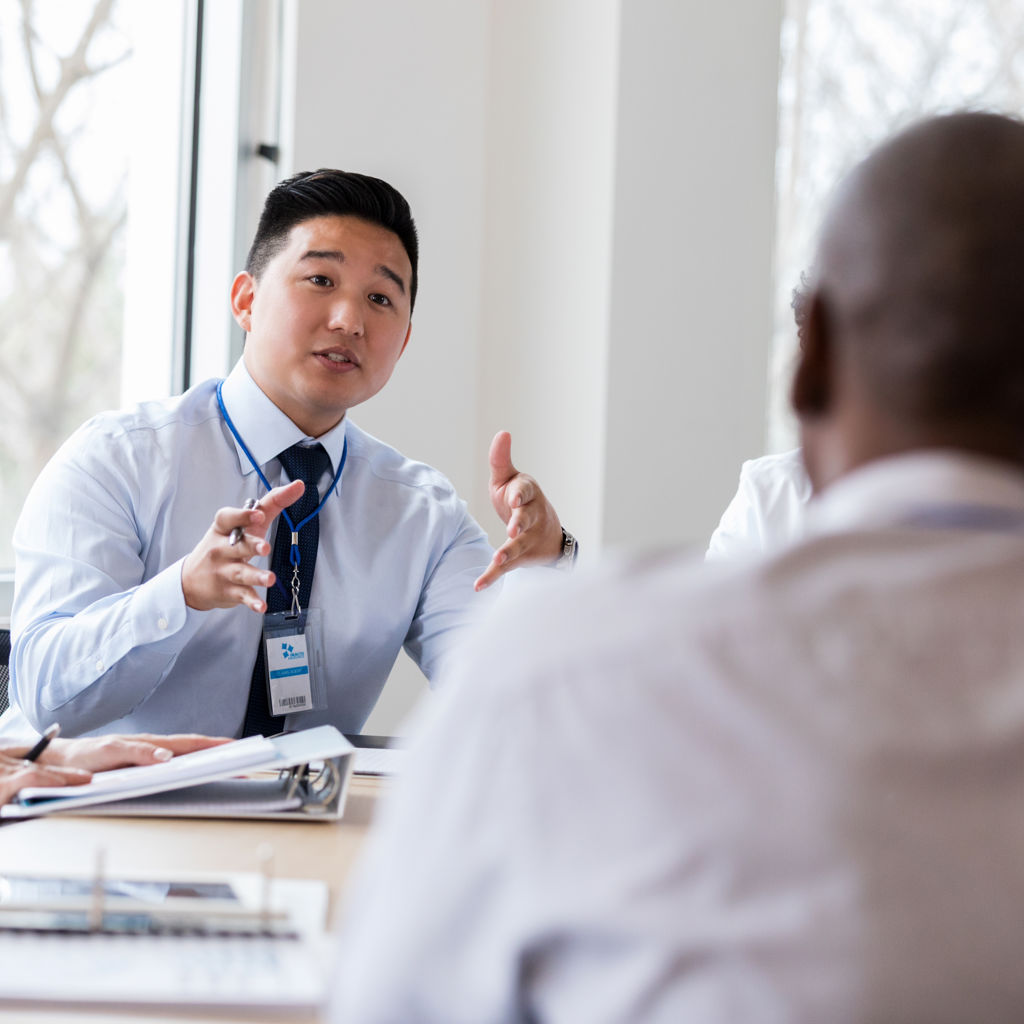 A businessman talking to his colleague in a meeting