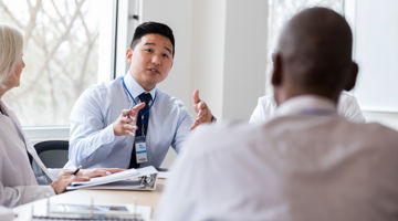 A businessman talking to his colleague in a meeting