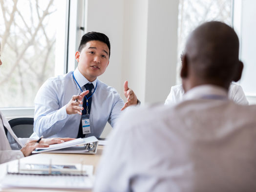 A businessman talking to his colleague in a meeting